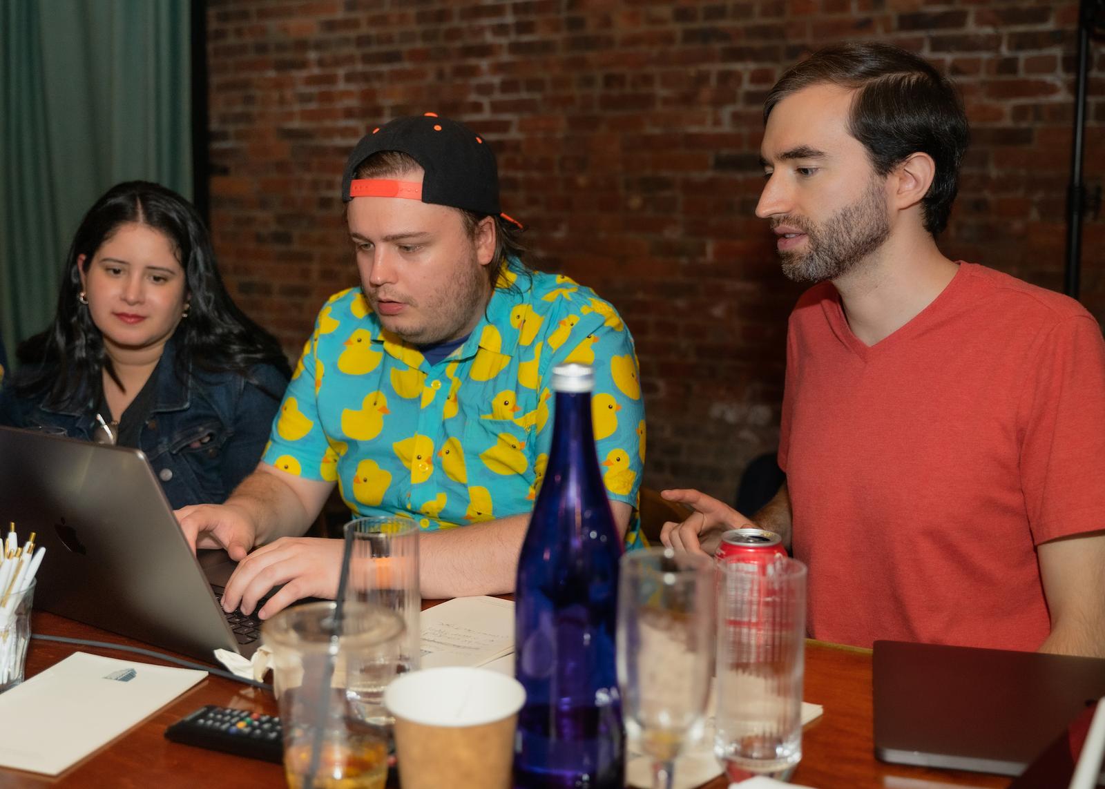 Three Lickability employees looking at a laptop together