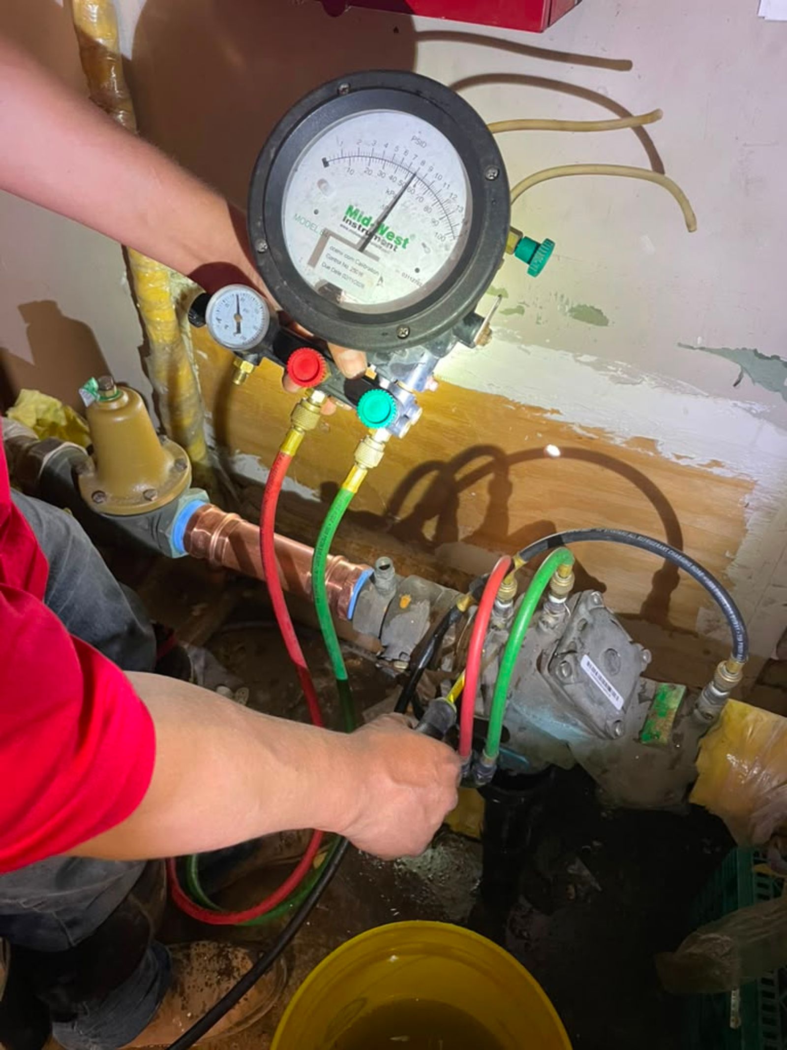 A differential pressure gauge connected to a backflow prevention assembly during an annual backflow test