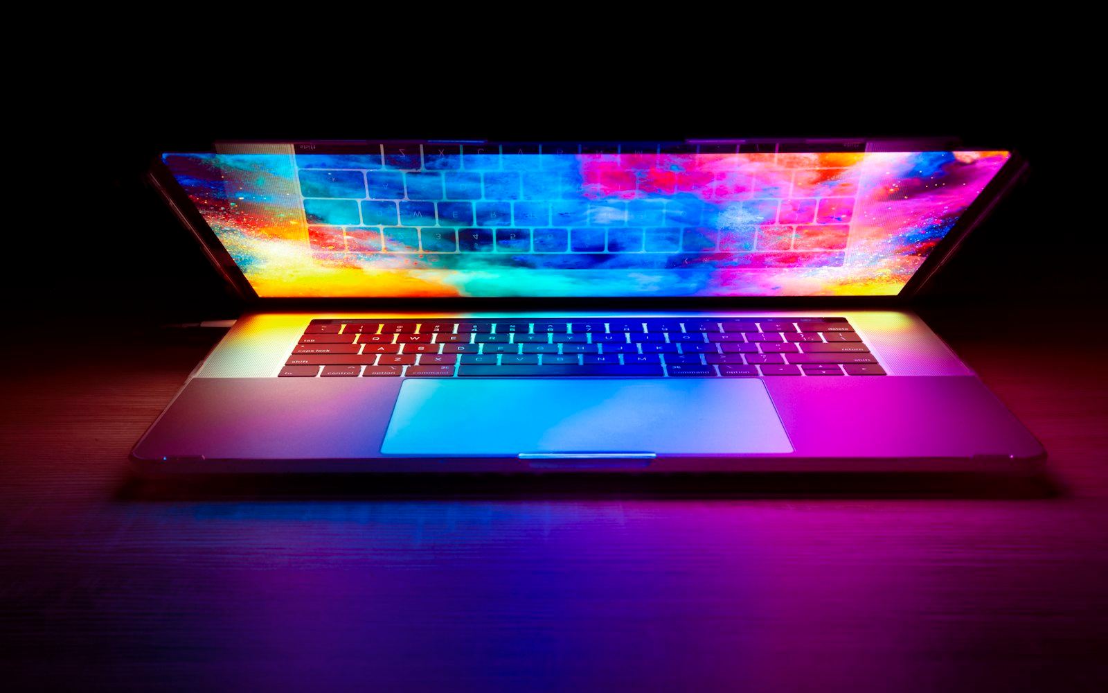 A laptop glowing in a dark room