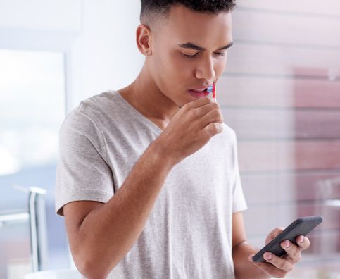 Man doing guided brushing with smart toothbrush