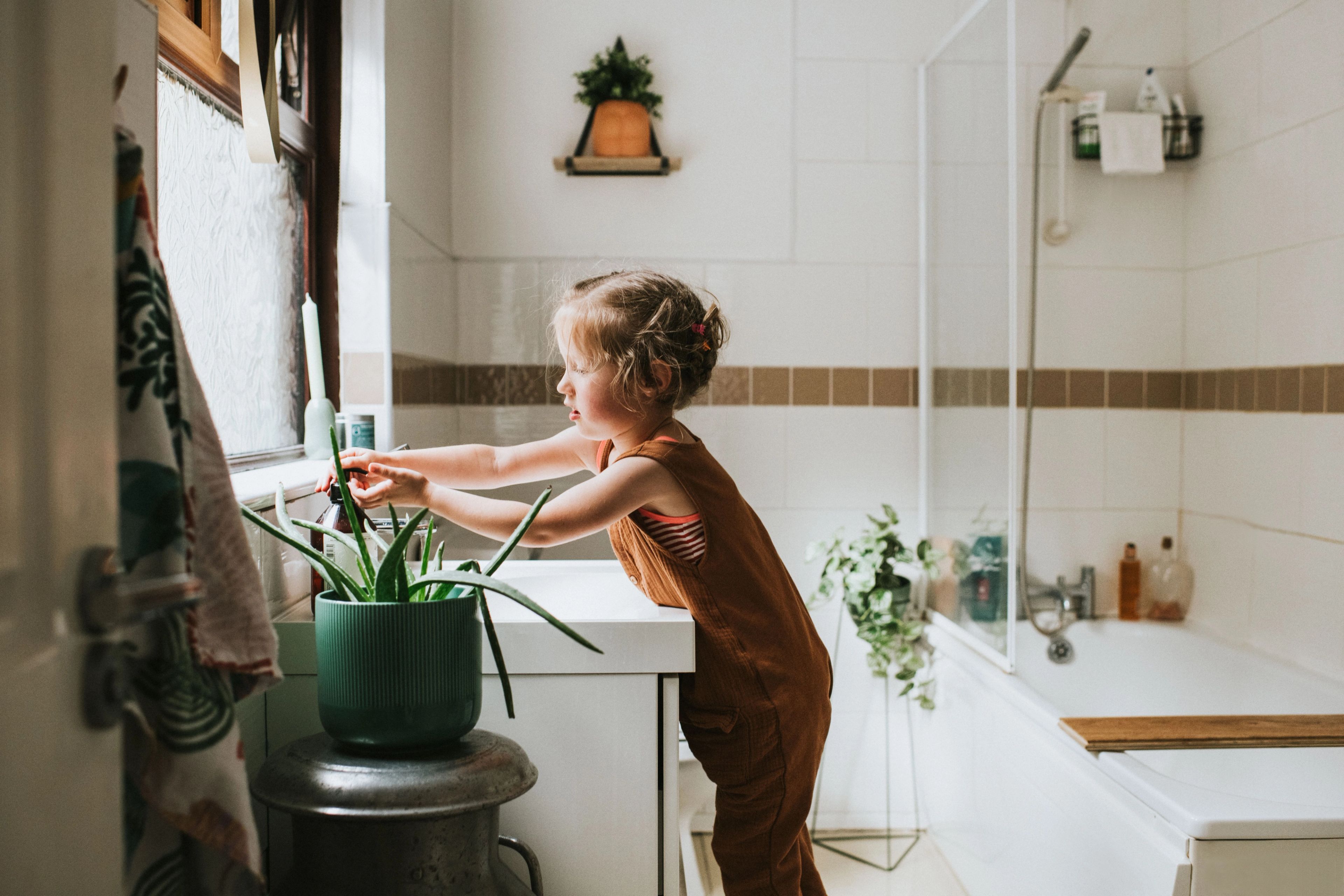 A girl washing hands in a bathroom