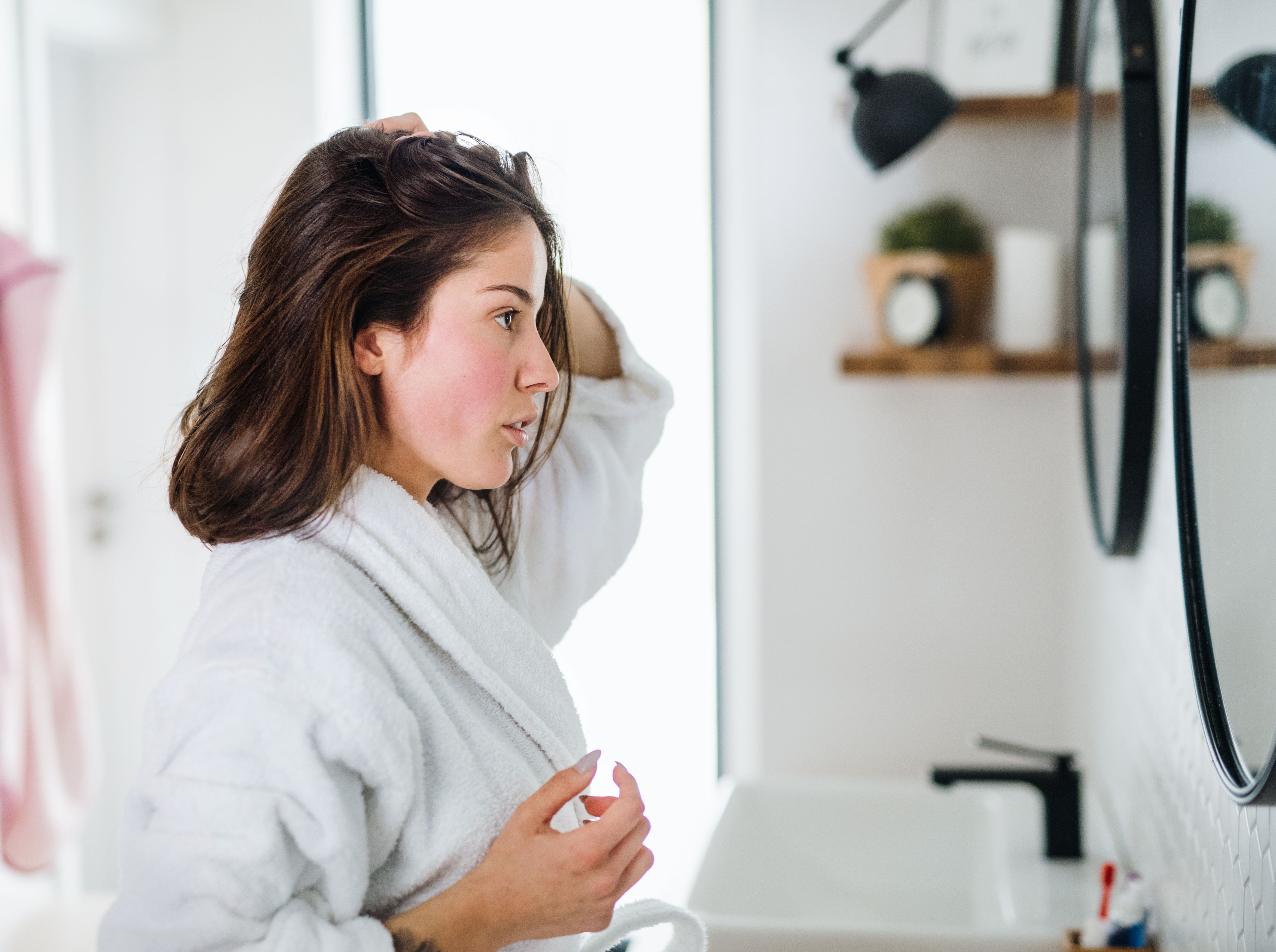 Woman looking into connected beauty mirror