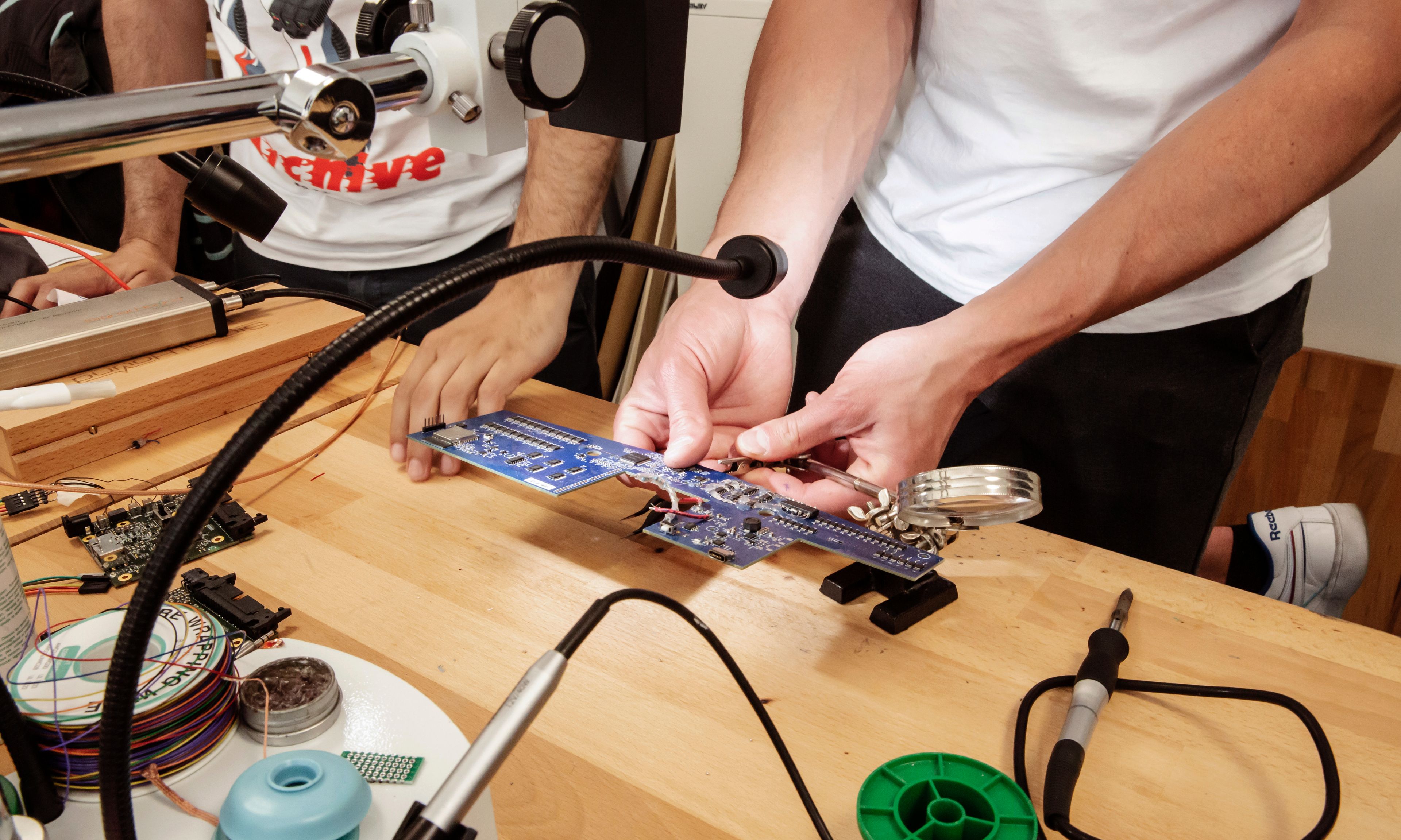 Man adjusting circuit board during product development 