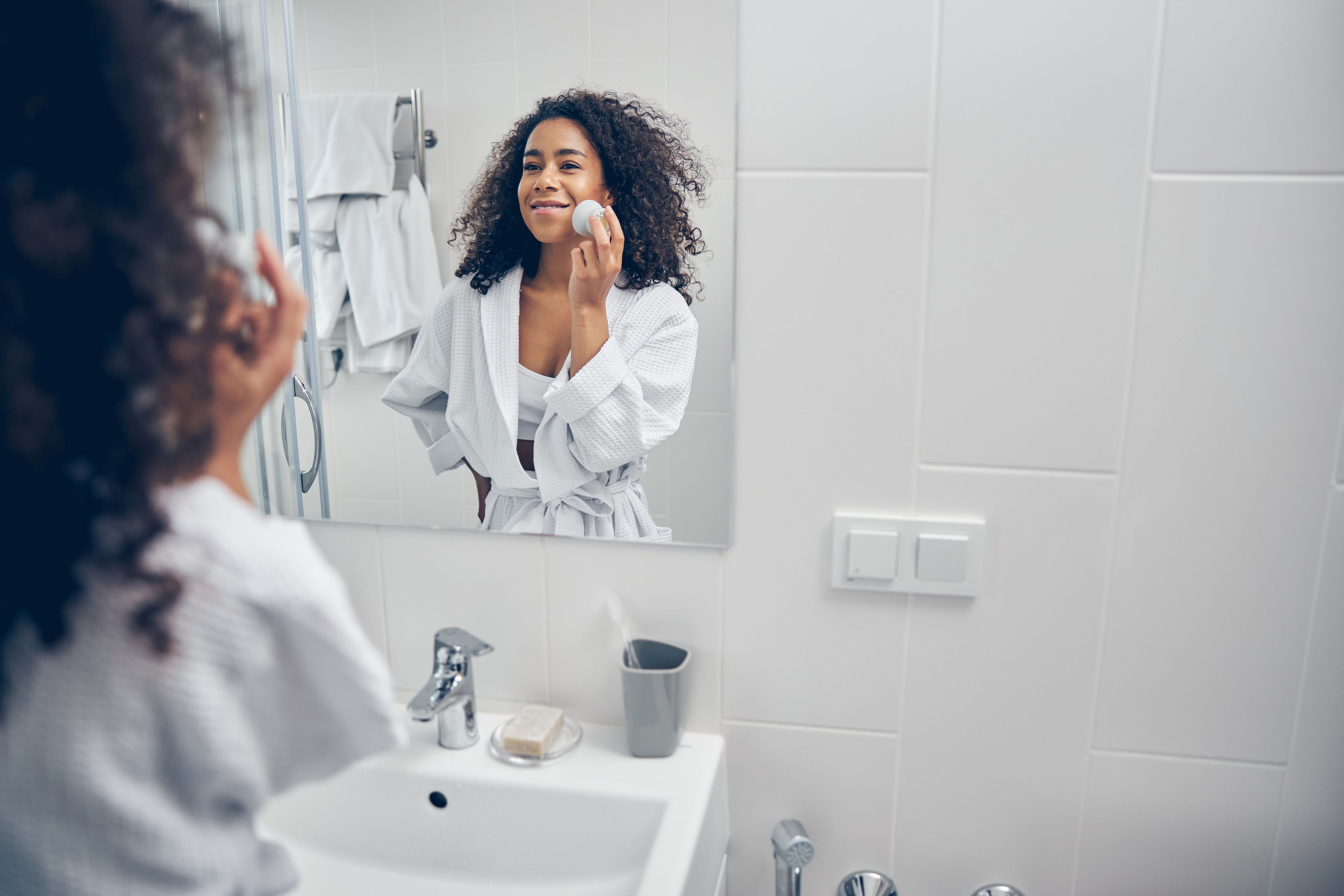 Woman doing skincare in the bathroom