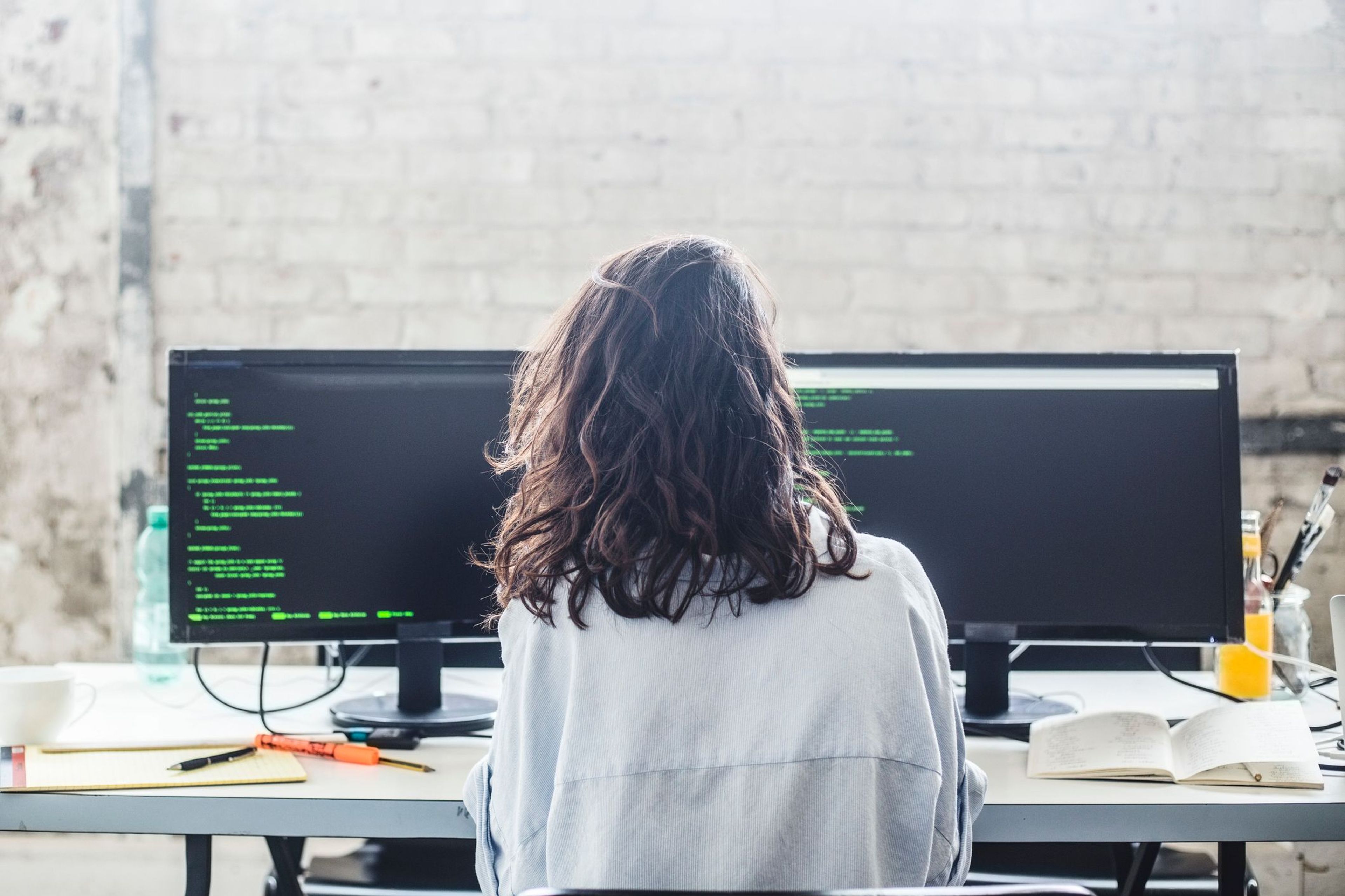Woman and computers with code