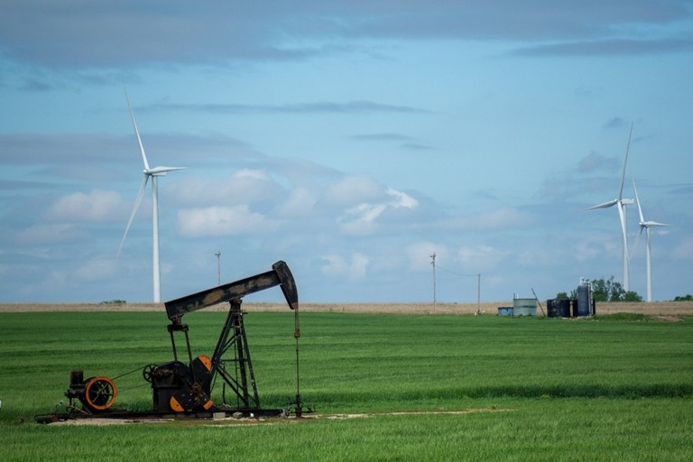 Image of wind farms beside a pumpjack in Western Canada