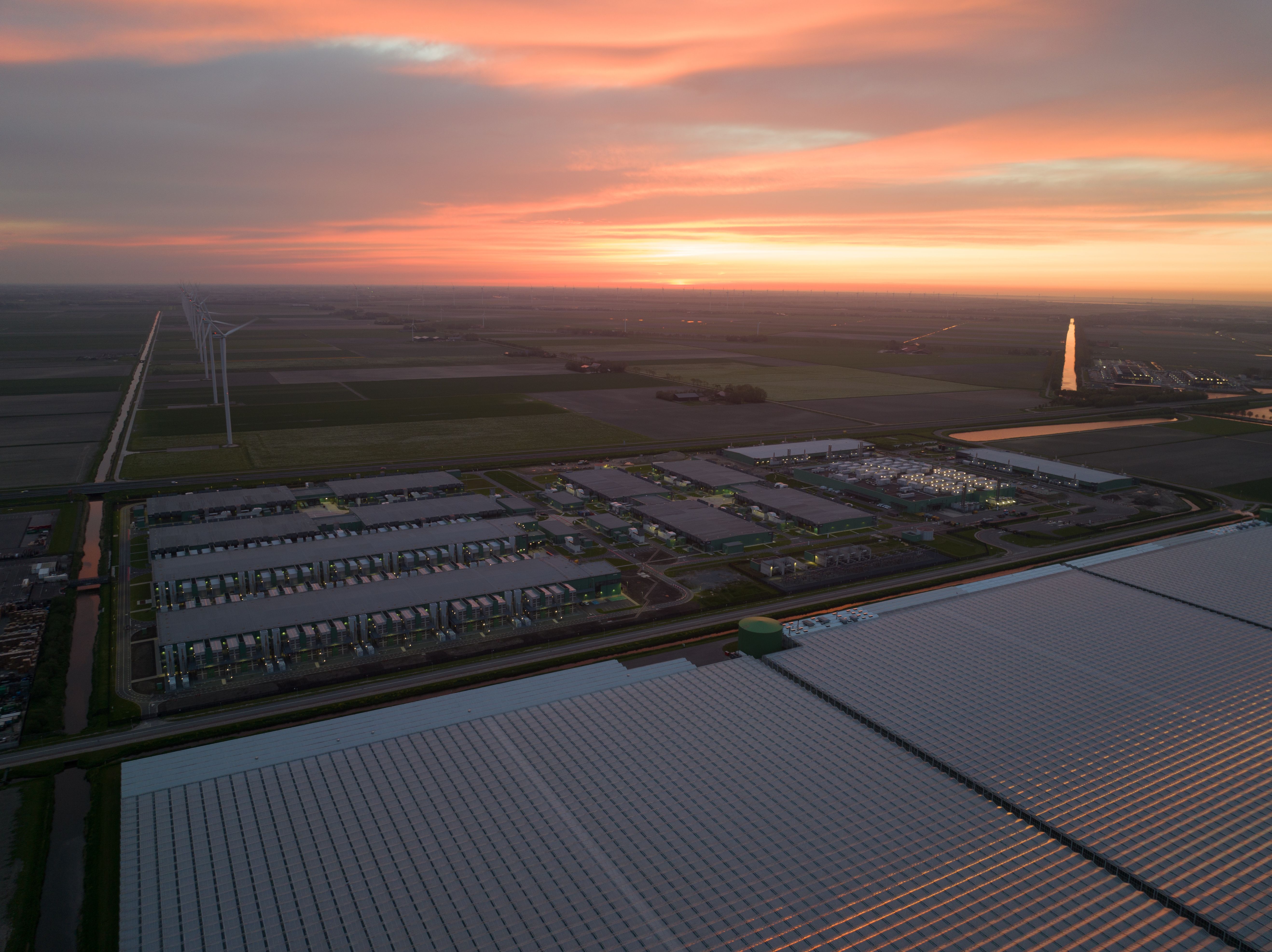 Large scale data center building complex in The Netherlands at night.
