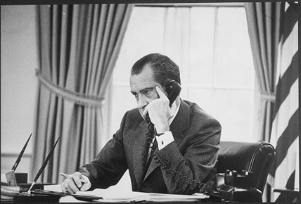 President Richard Nixon sitting in the Oval Office