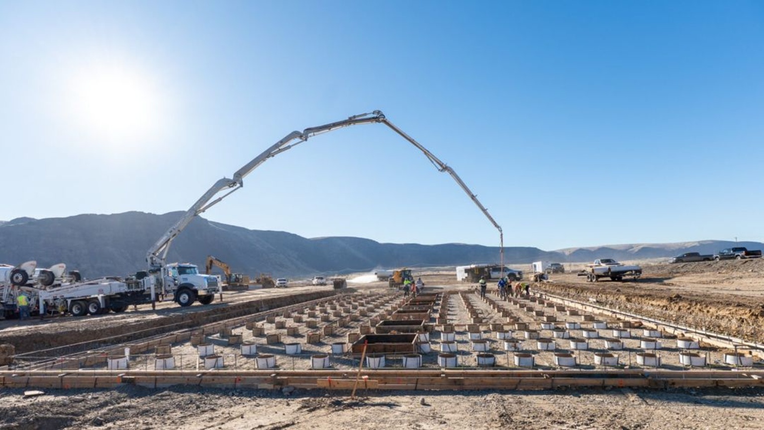 An image of a concrete pump truck laying the foundation for Helion’s Orion project in Malaga, Washington