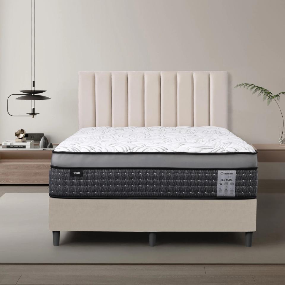 Dreamland Pegasus Plush mattress, queen size, shown front-on in a styled bedroom.