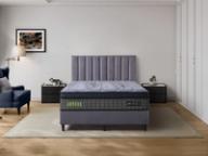 Dreamland Aurora mattress on a black base in a styled bedroom.