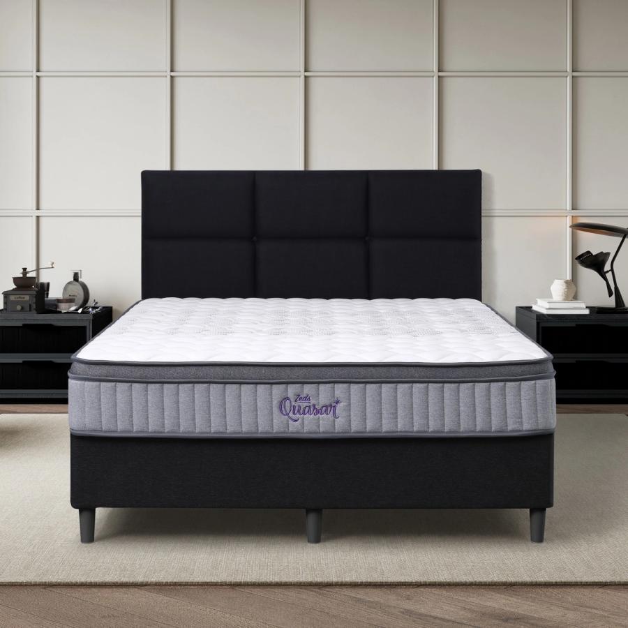Dreamland Quasar mattress, queen size, shown front-on in a styled bedroom.