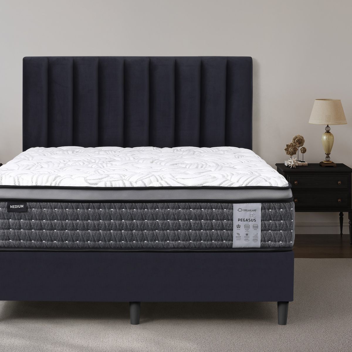 Dreamland Pegasus Medium mattress, queen size, shown front-on in a styled bedroom.