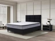 Dreamland Quasar mattress, queen size, angled view in a styled bedroom.