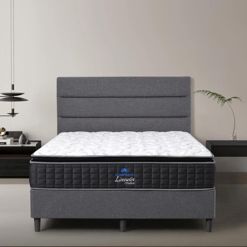 Dreamland Lincoln Medium mattress, queen size, shown front-on in a styled bedroom.
