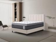 Dreamland Pegasus Plush mattress, queen size, angled view in a styled bedroom.