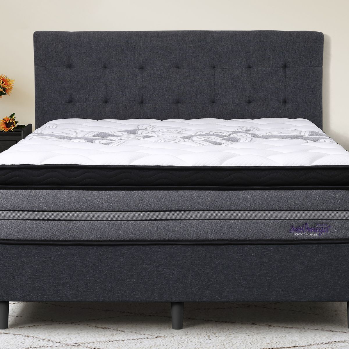 Dreamland Omega Plush mattress, queen size, shown front-on in a styled bedroom.