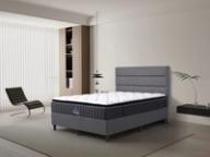Dreamland Lincoln Medium mattress, queen size, angled view in a styled bedroom.