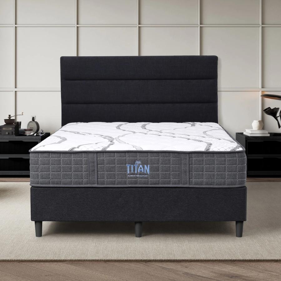 Dreamland Titan mattress, queen size, shown front-on in a styled bedroom.