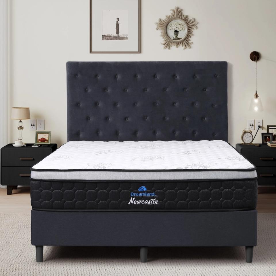 Dreamland Newcastle mattress, queen size, shown front-on in a styled bedroom.