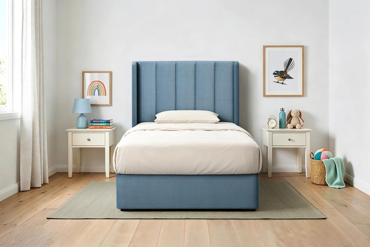 Theo upholstered king single bed frame in blue, made up in a child’s bedroom