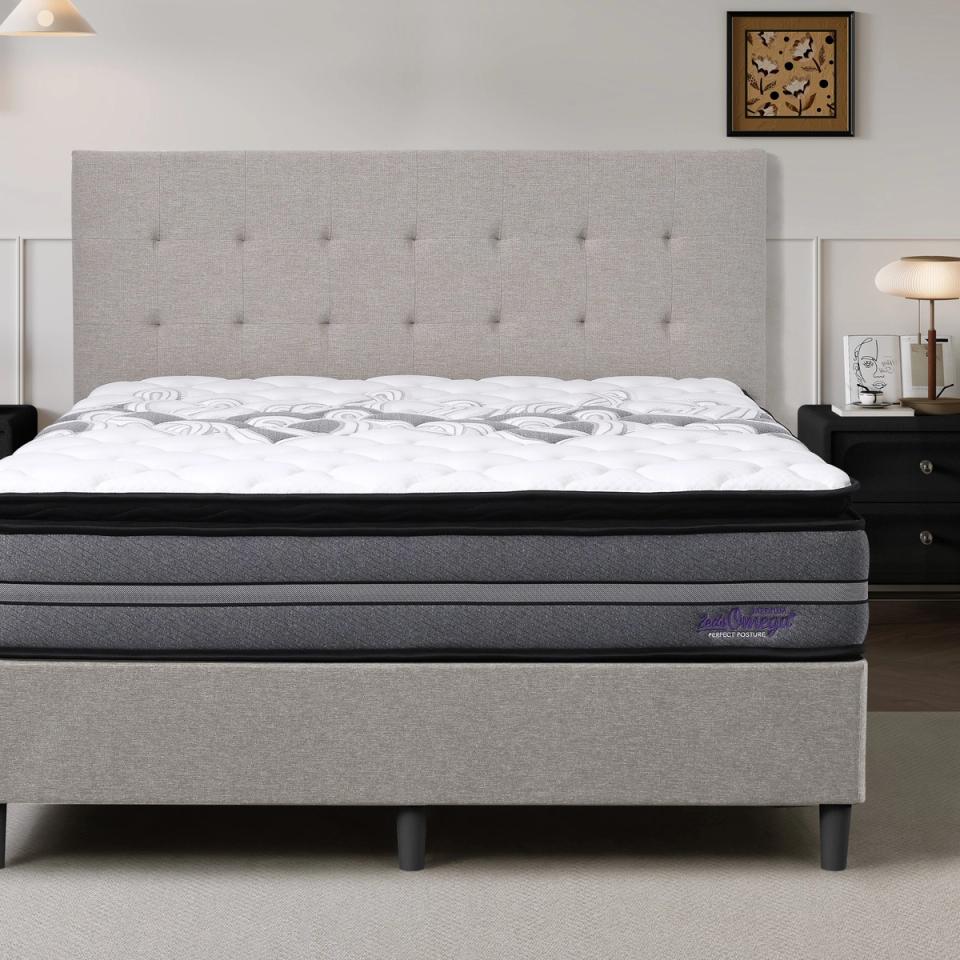 Dreamland Omega Medium mattress, queen size, shown front-on in a styled bedroom.