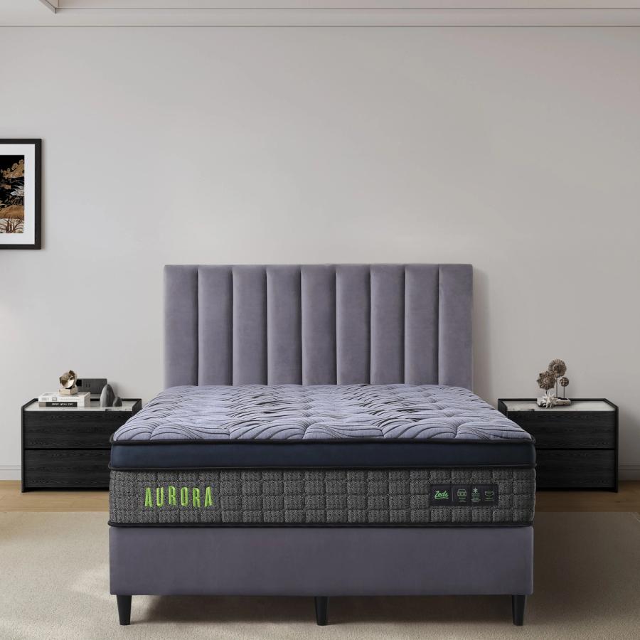 Dreamland Aurora mattress, queen size, shown front-on in a styled bedroom.