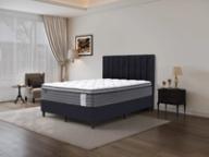 Dreamland Pegasus Medium mattress, queen size, angled view in a styled bedroom.