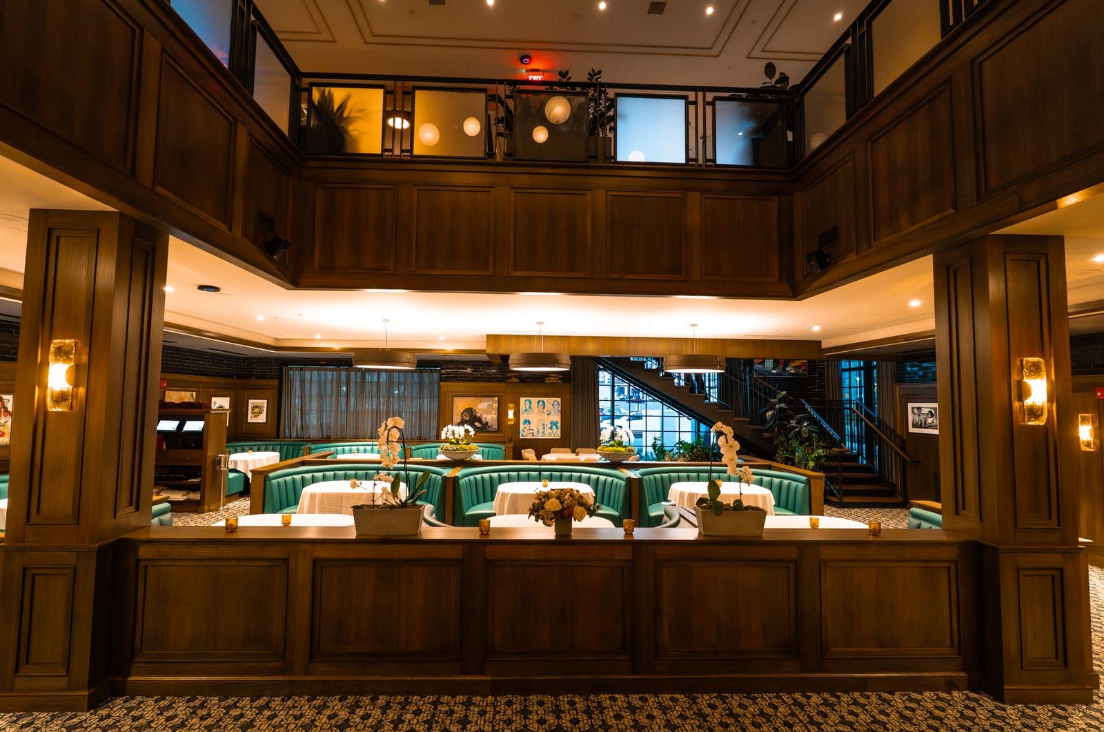 Mezzanine view over the dining room's booths and white-clothed tables