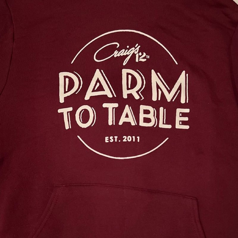 A maroon Craig's LA tee folded beside the brand card