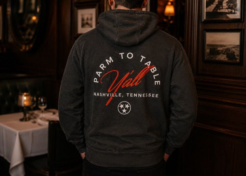 A black Craig's Nashville sweatshirt folded on marble