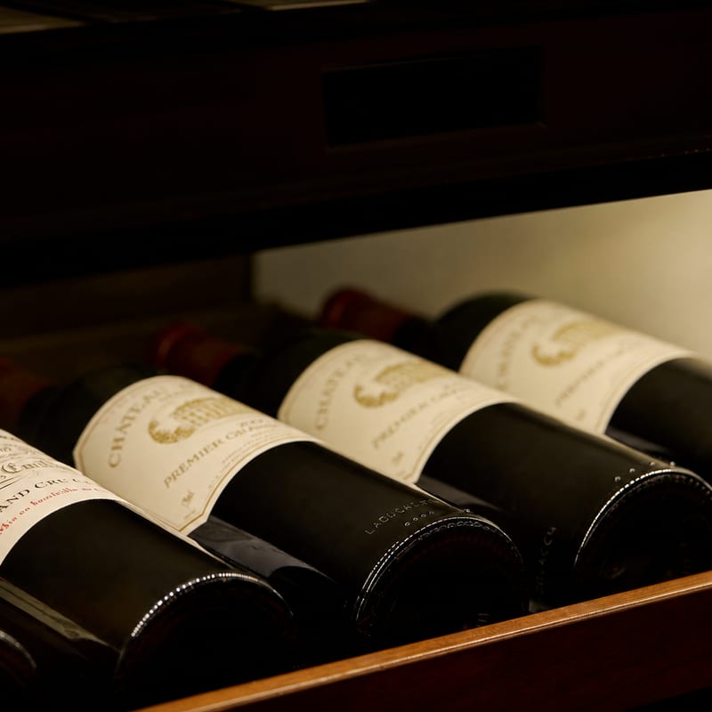 Wine bottles resting in the rack of the Craig's cellar