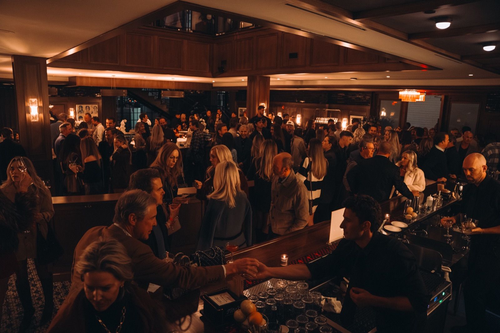 A packed private event around the bar at Craig's Nashville