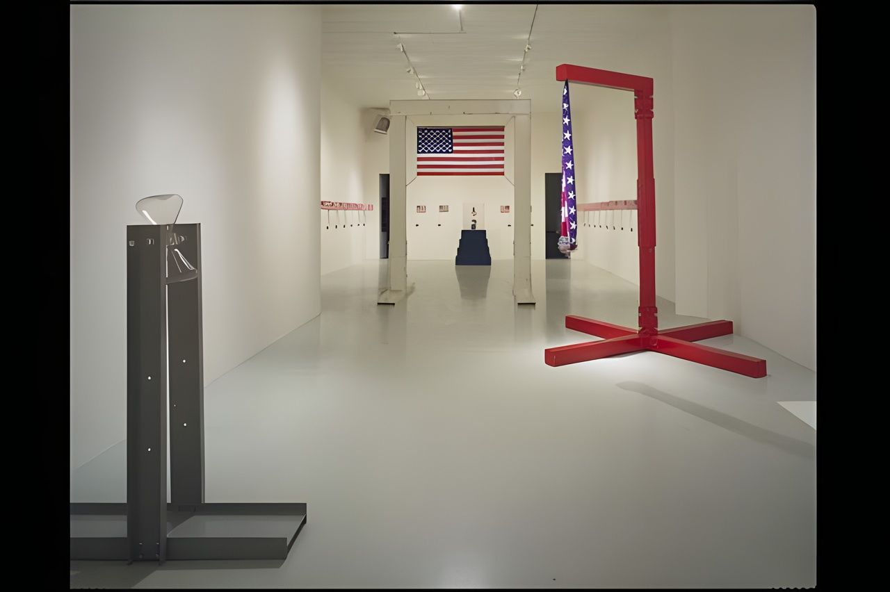 Andrew Krasnow, U.S. Habitus, installation view, 1992: a long white gallery with an American flag, a red steel archway and parade flags along the walls.