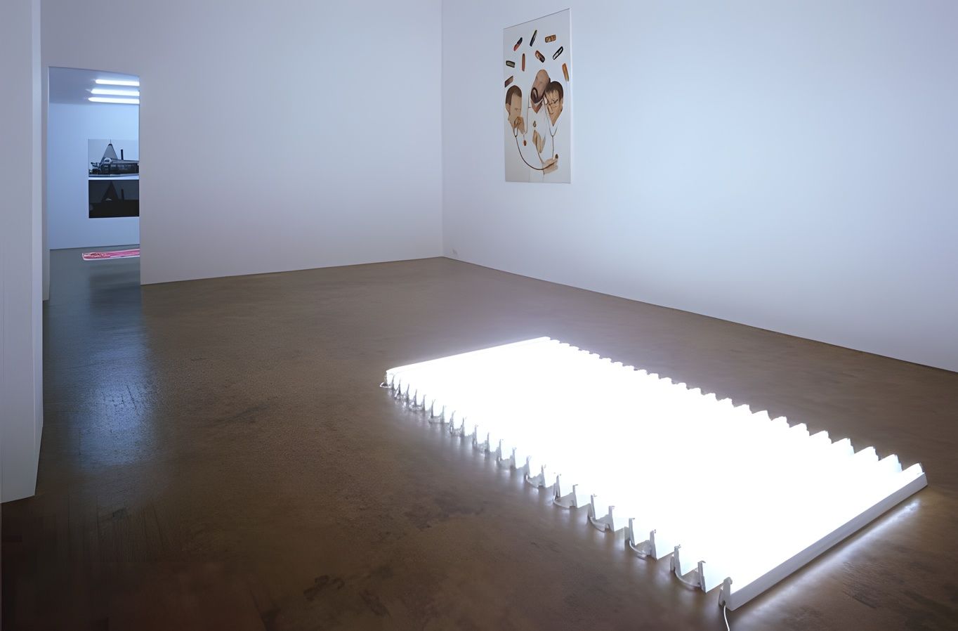 General Idea, MAGI© BULLET, installation view at Stefan Stux Gallery, 1992: a long, brightly lit work on the floor of an empty white gallery.