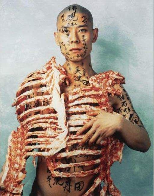 Zhang Huan, Meat and Text, 1998. C-print: the artist with raw meat draped over his bare body.
