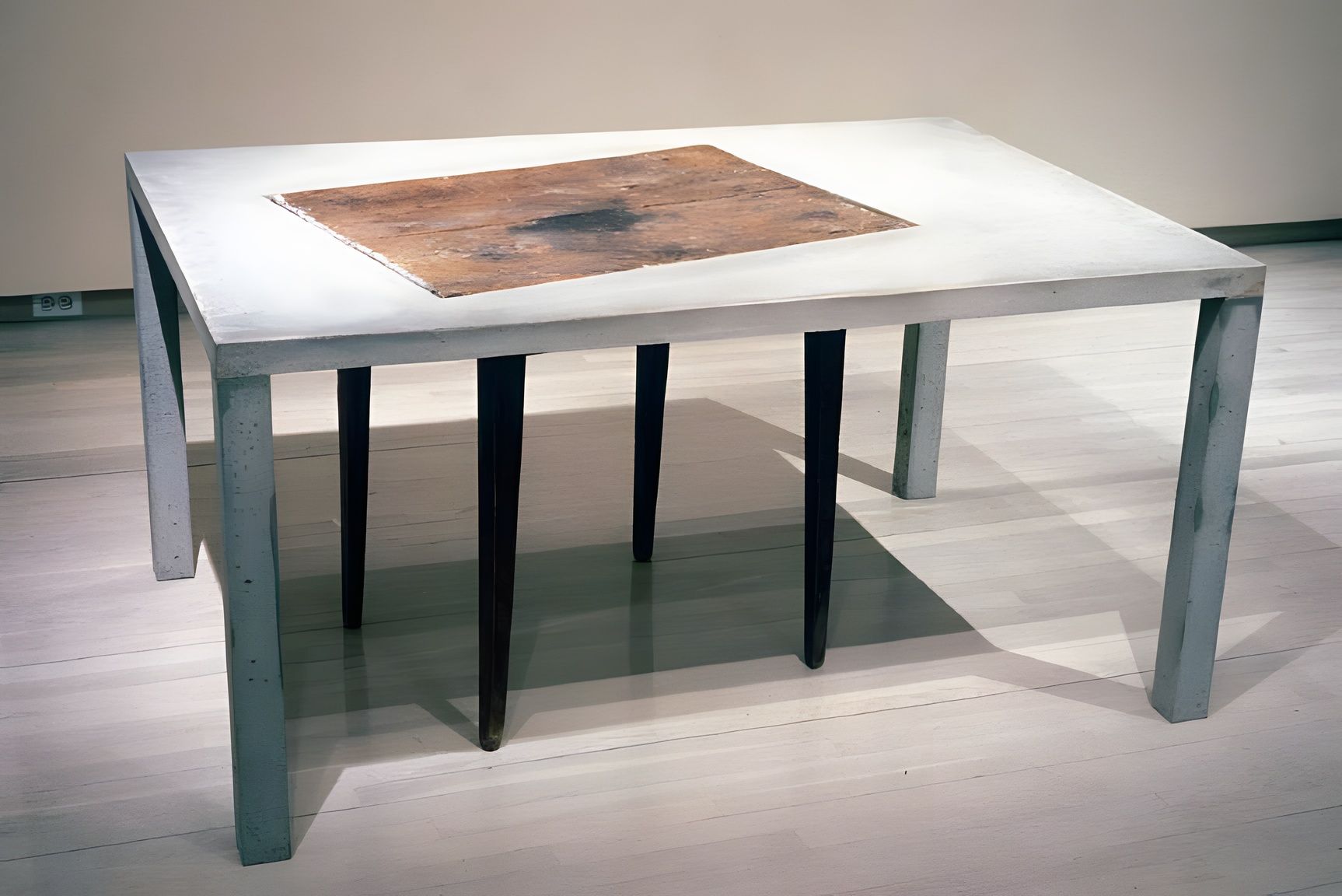 Jeffrey Schiff, installation view at Stux Gallery SoHo: a low table with tapered legs and a worn top in an empty gallery.