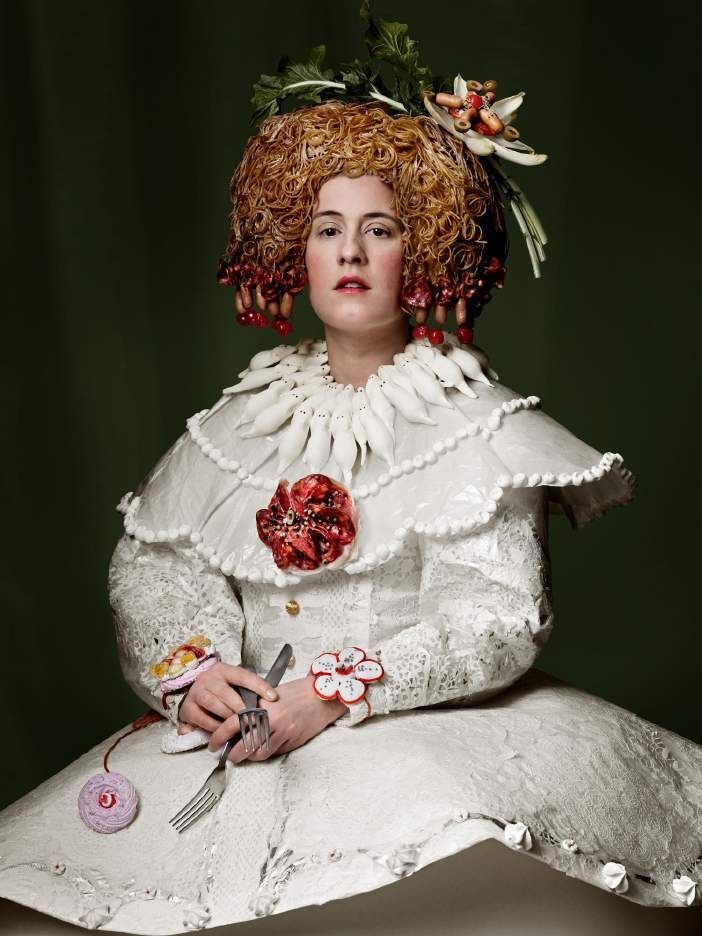 Josef Fischnaller, Infantin Eva, 2010. C-print: a pale young woman in a white ruffled costume with flowers in her red hair.