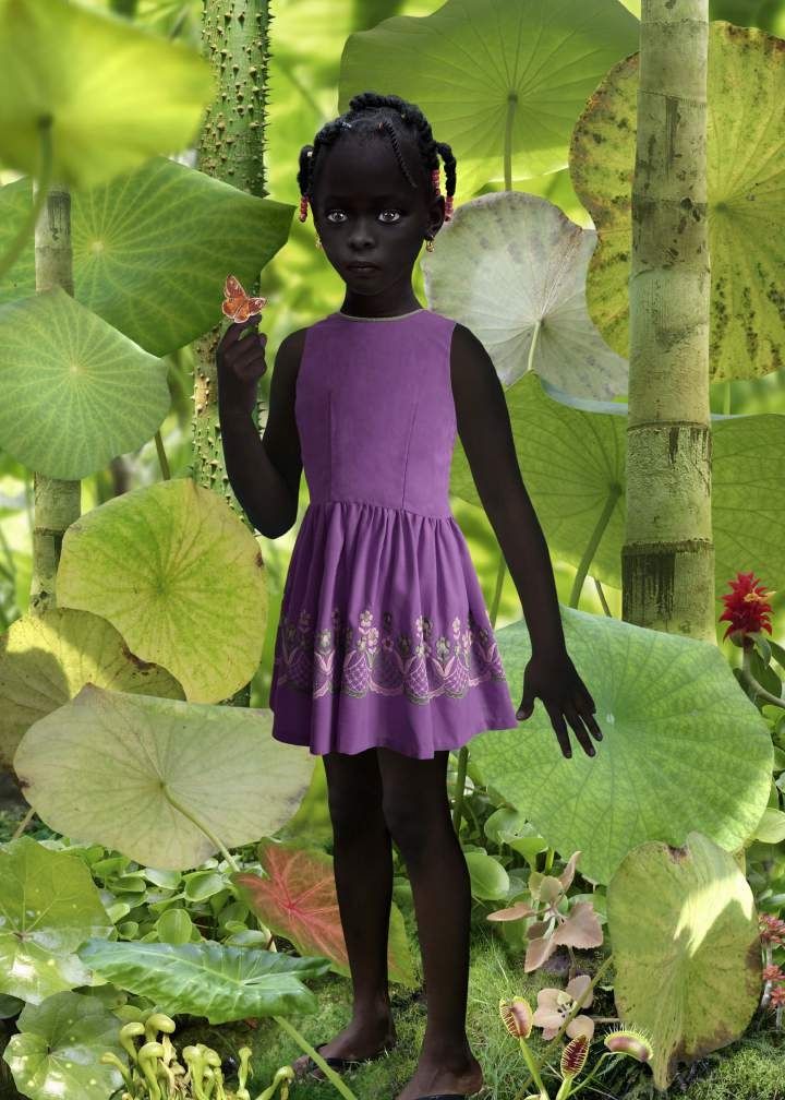Ruud van Empel, World #11, 2005. Cibachrome: a young girl in a purple dress standing in a lush green jungle.