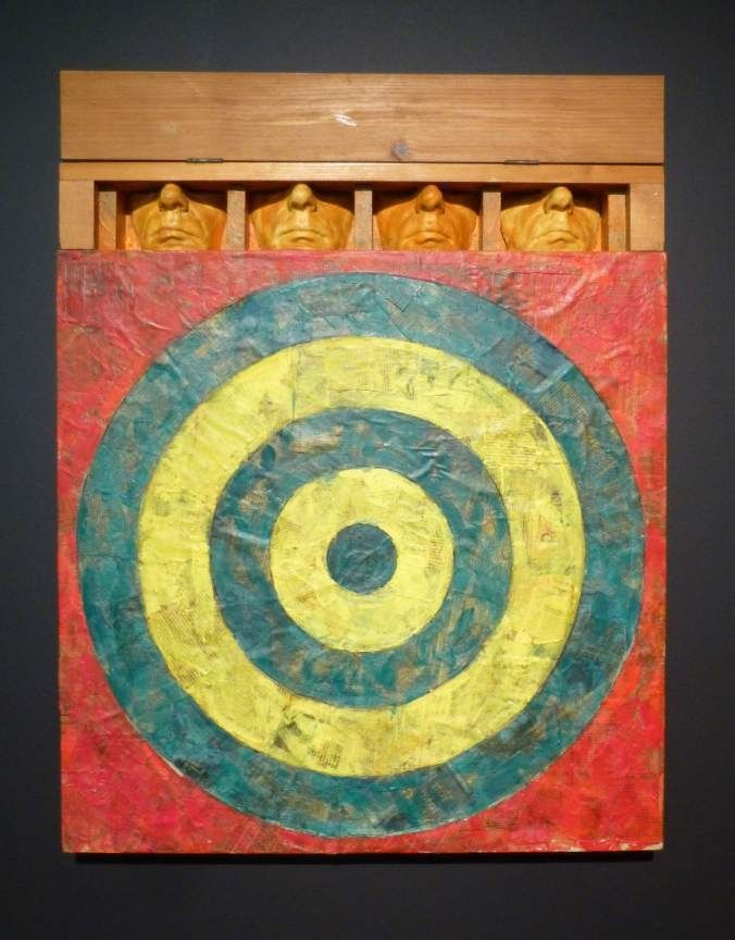 Sturtevant, Johns Target with Four Faces, 1987–90. Encaustic and collage: a target in yellow, red and blue below four plaster face casts in a wooden box.