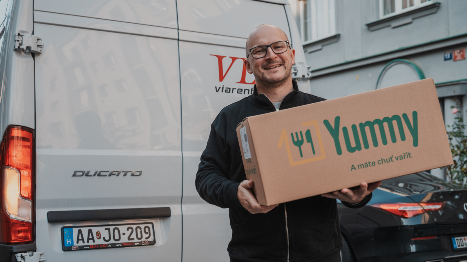 a man delivering Yummy box