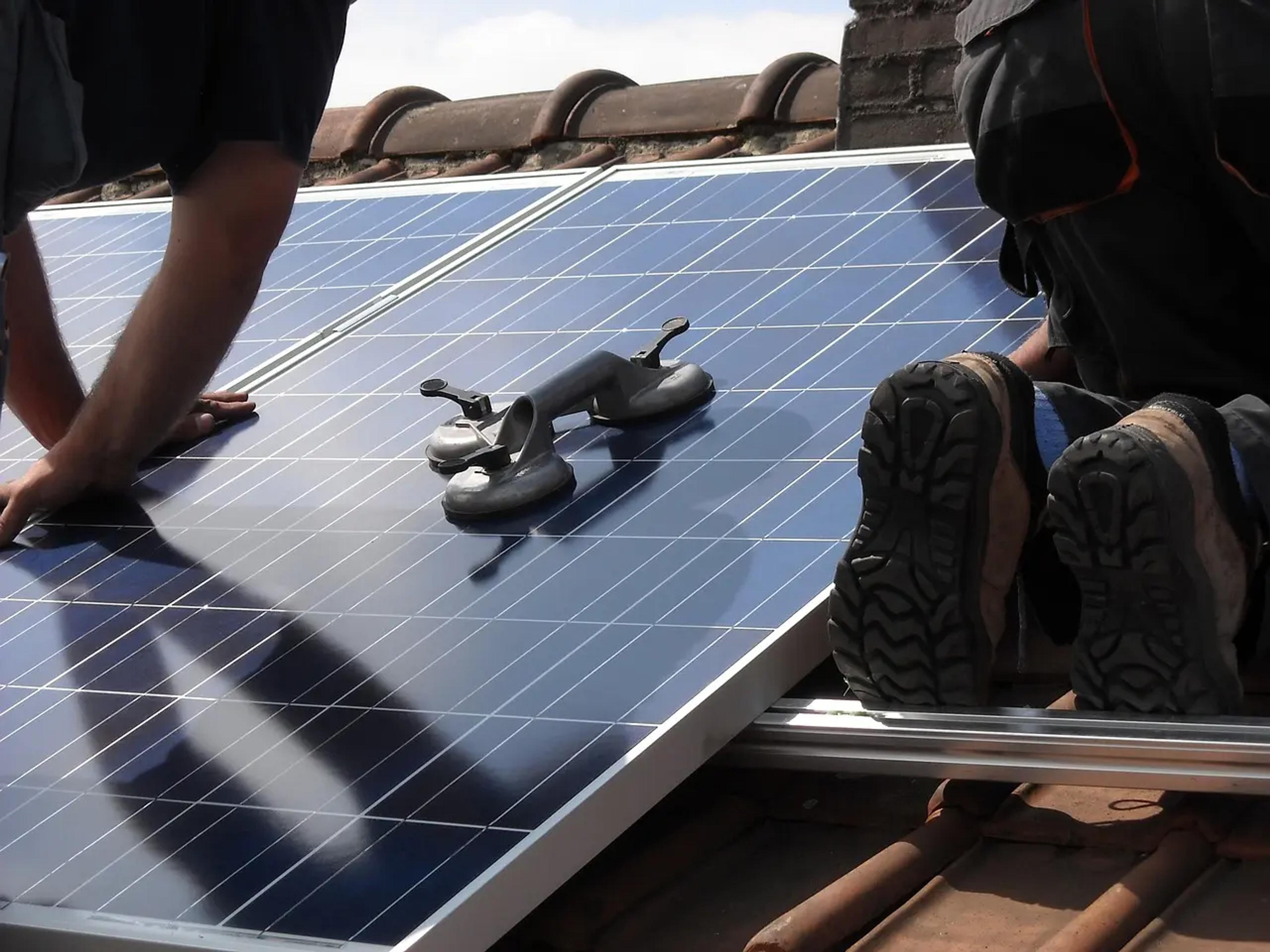 Solar panels being installed on a roof