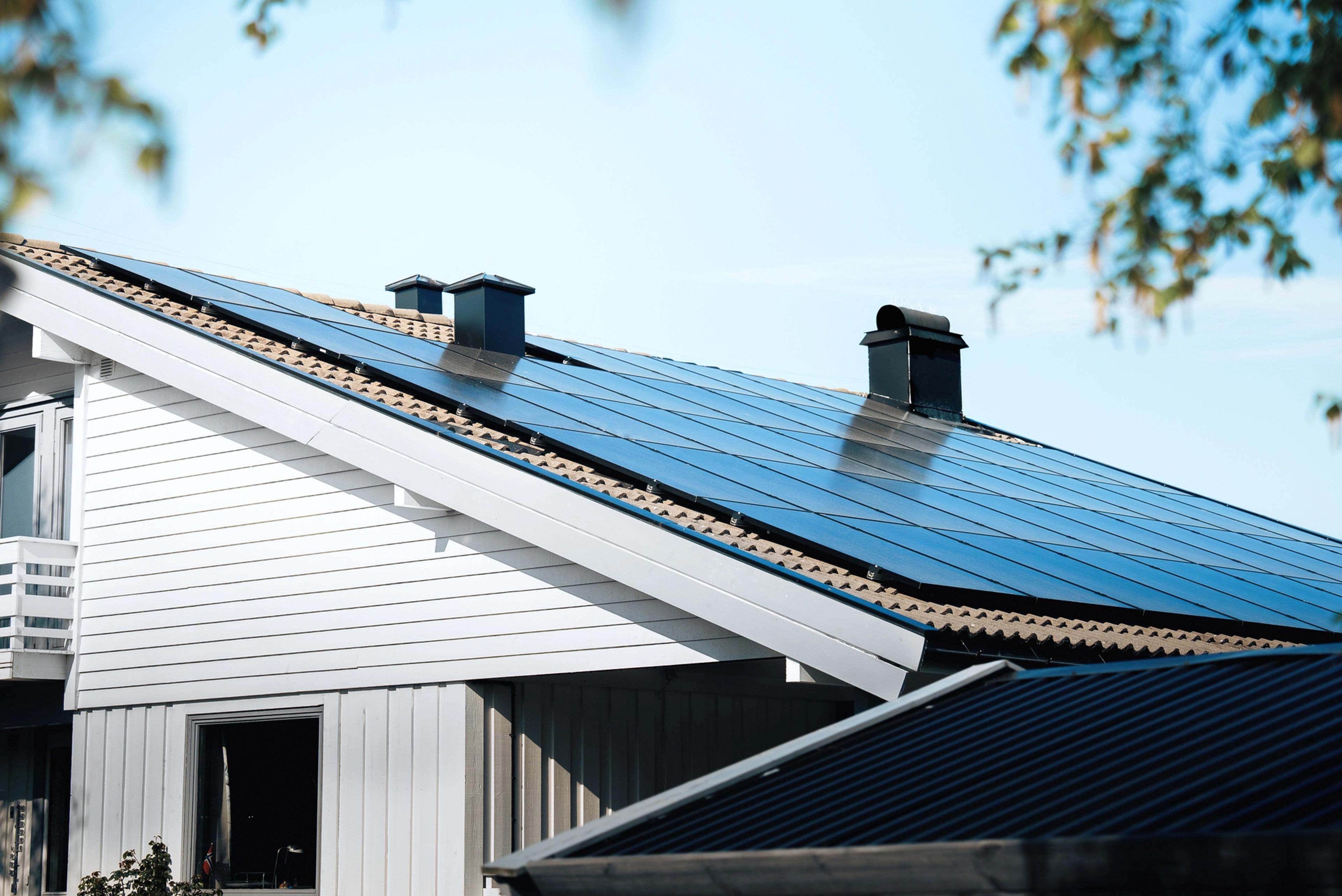 Solar panels on the roof of a white house