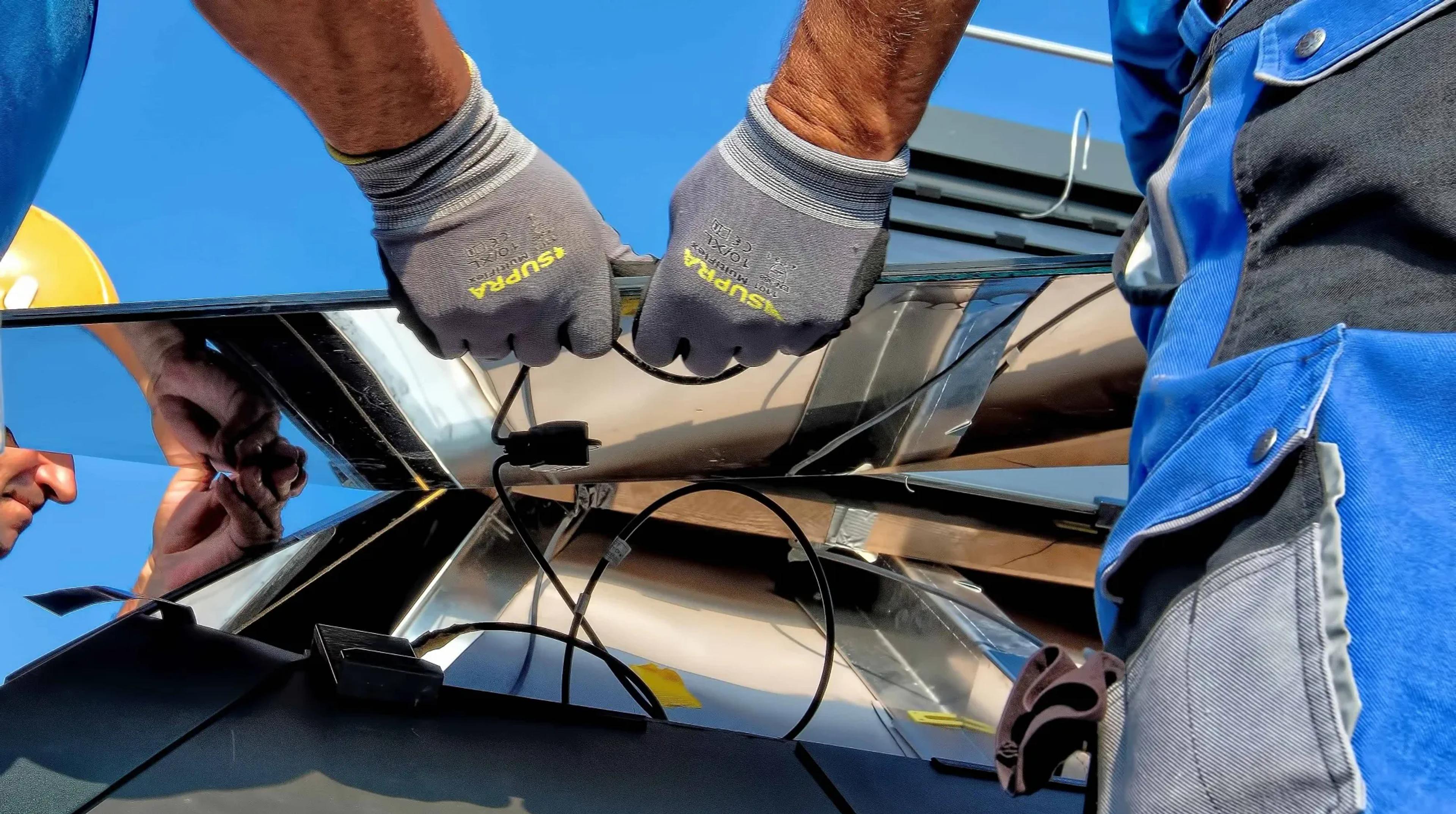 Men installing a solar panel syste