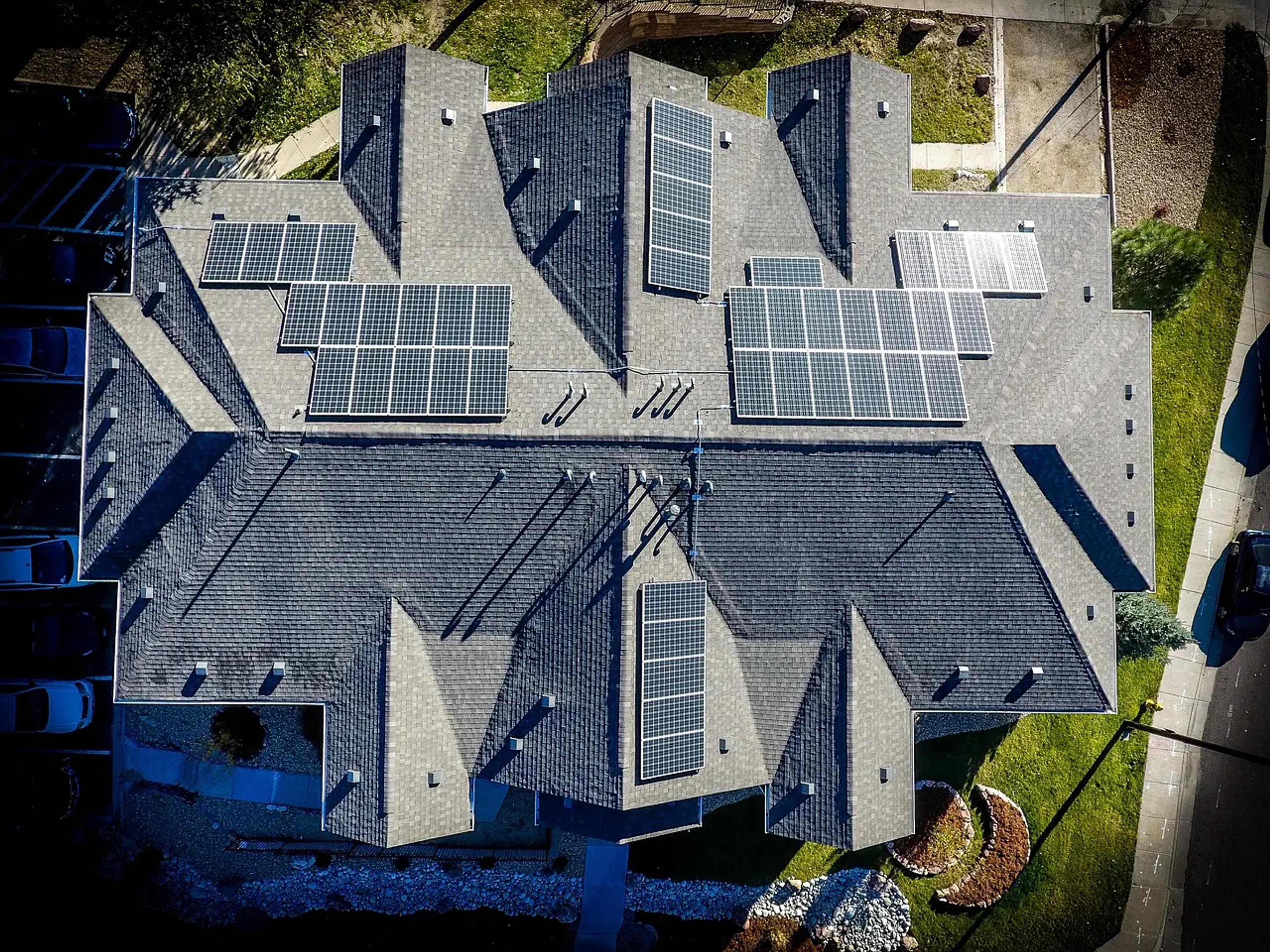 Aerial view of two adjoining homes with solar panels on the roof. 