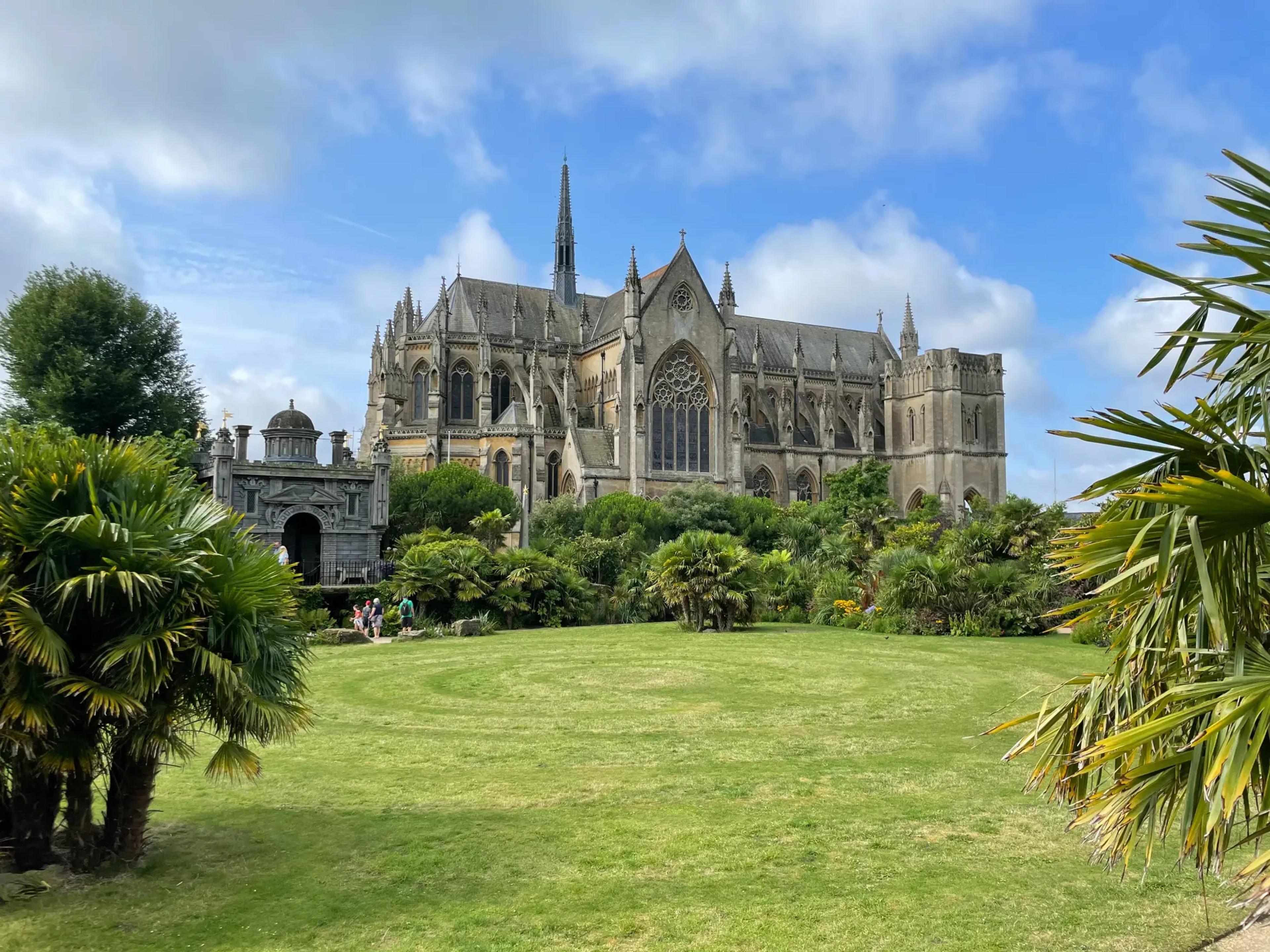 A view of Arundel Cathedral across the lawn. The sky is blue and clear.