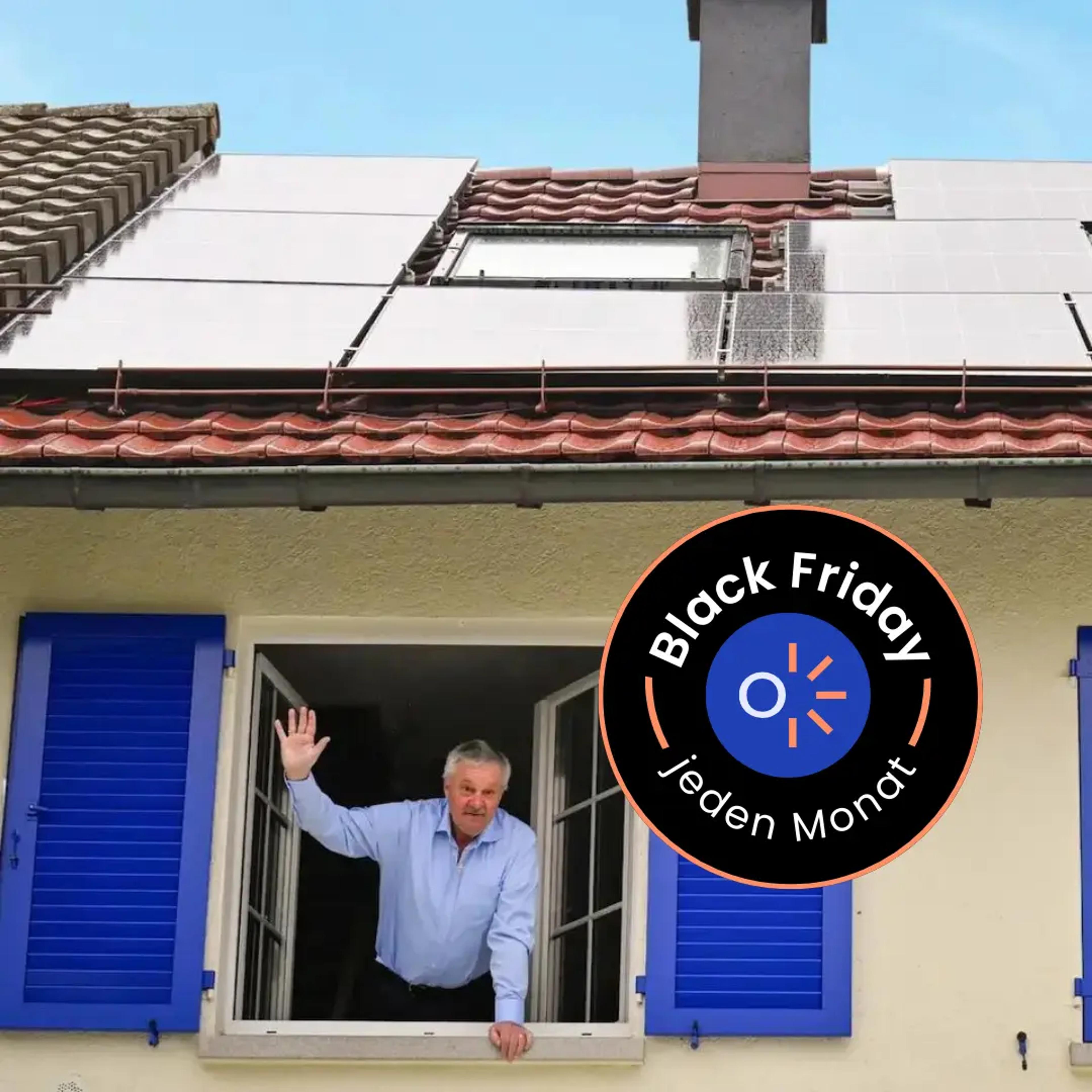 Ein Otovo Kunde steht im Fenster eines Hauses, auf dem eine Solaranlage installiert ist.