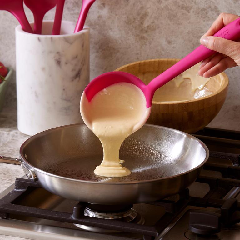 A Ruby Ladle pouring pancake batter.