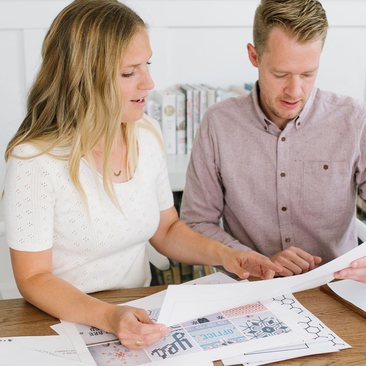 Founders Joanna and Johnny looking at a piece of paper together.