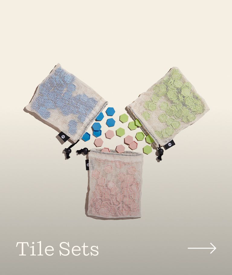 Three bags of tile sets pouring into one another.